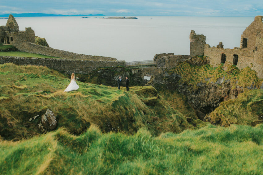 Bride approaching a Dunluce Castle elopement ceremony on the Northern Ireland coast